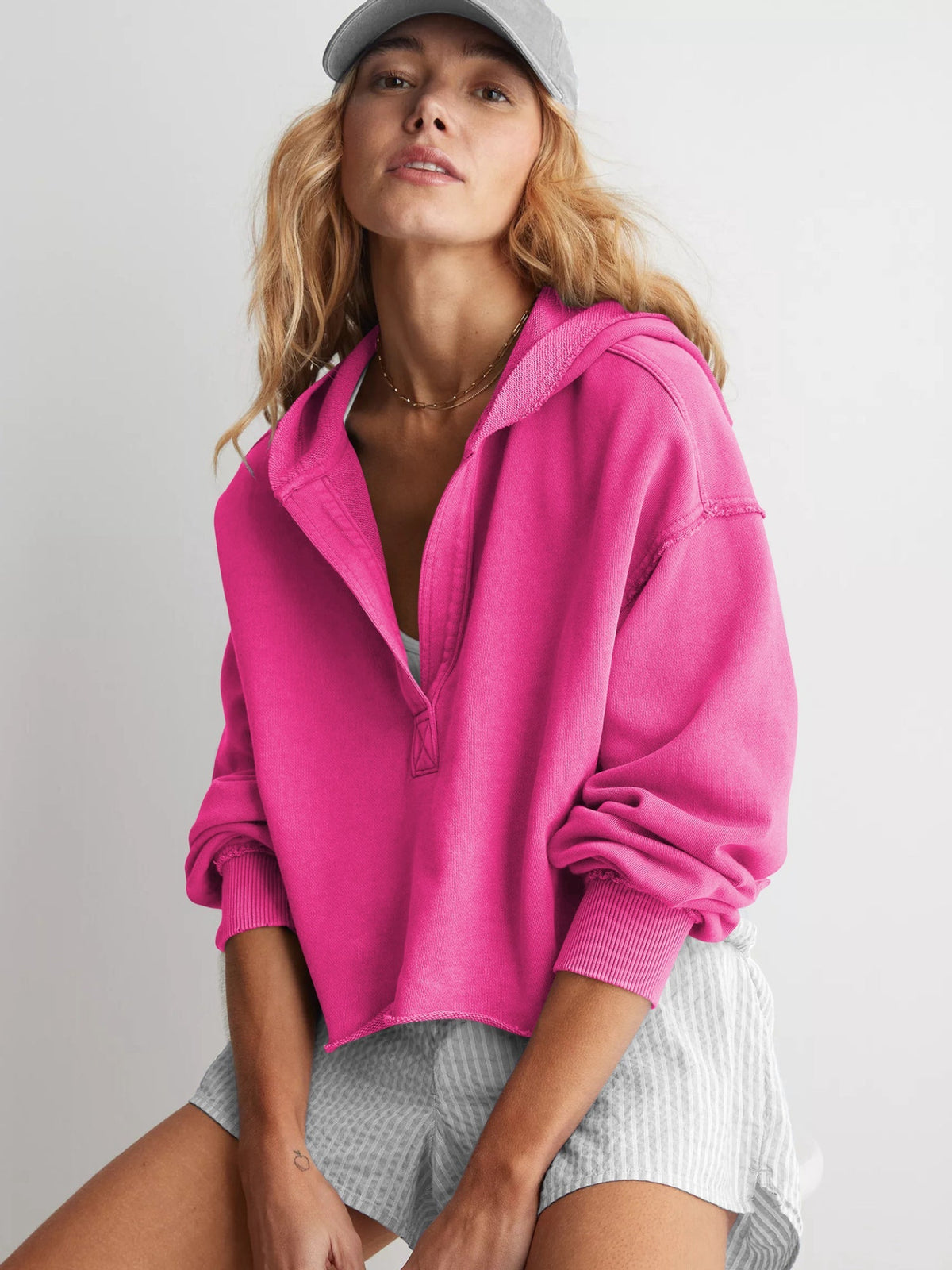 Women's relaxed hooded half-zip hoodie with long sleeves and ribbed trims