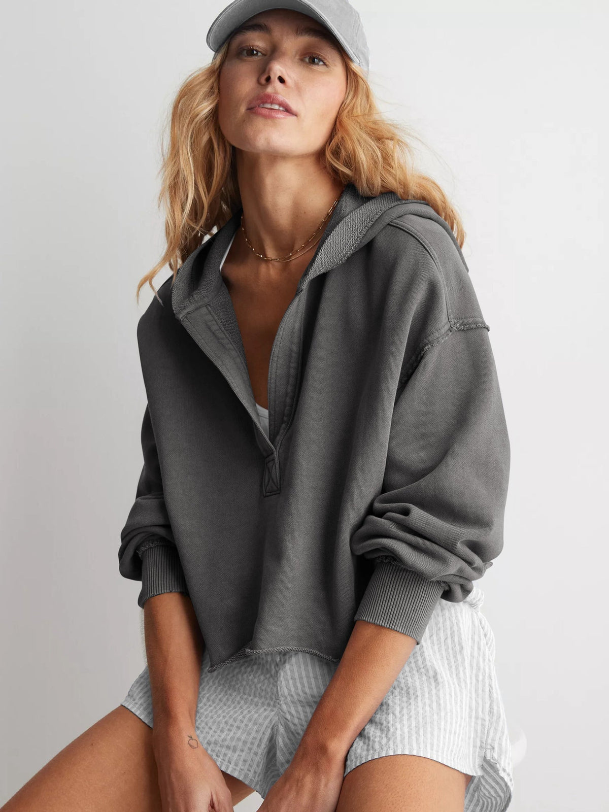 Women's relaxed hooded half-zip hoodie with long sleeves and ribbed trims