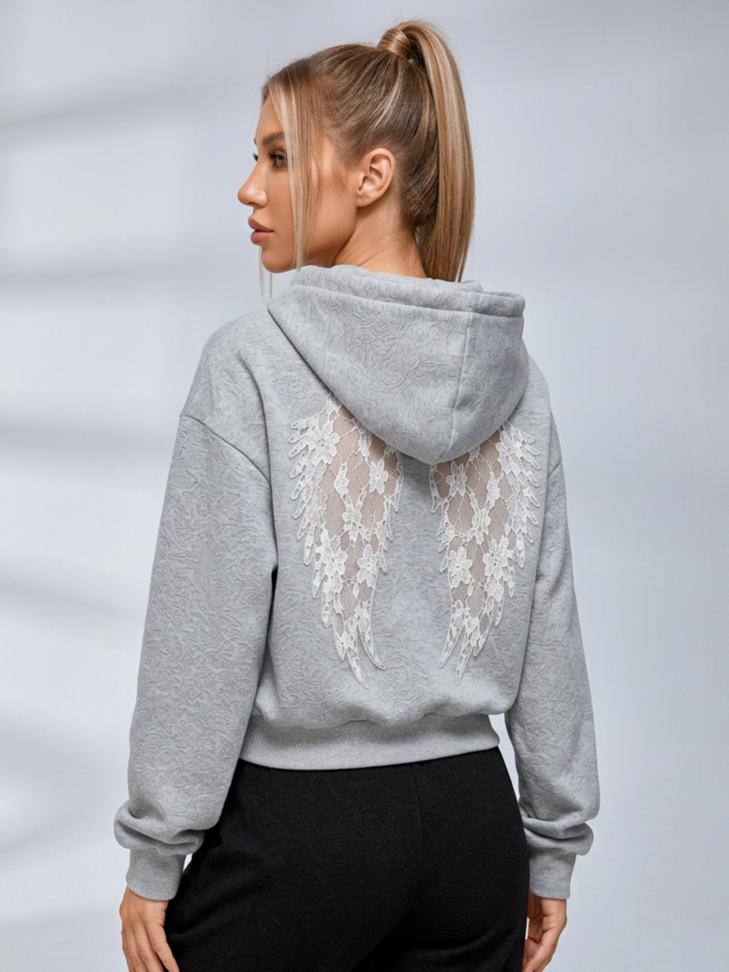 Women's cropped embossed hoodie with drawstring hood and wing back detail