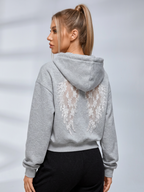 Women's cropped embossed hoodie with drawstring hood and wing back detail