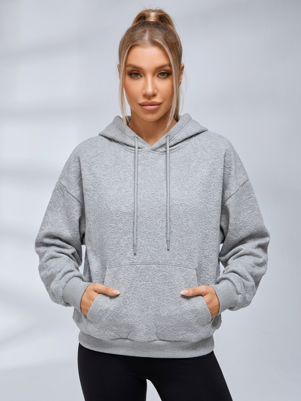 Women's cropped embossed hoodie with drawstring hood and wing back detail