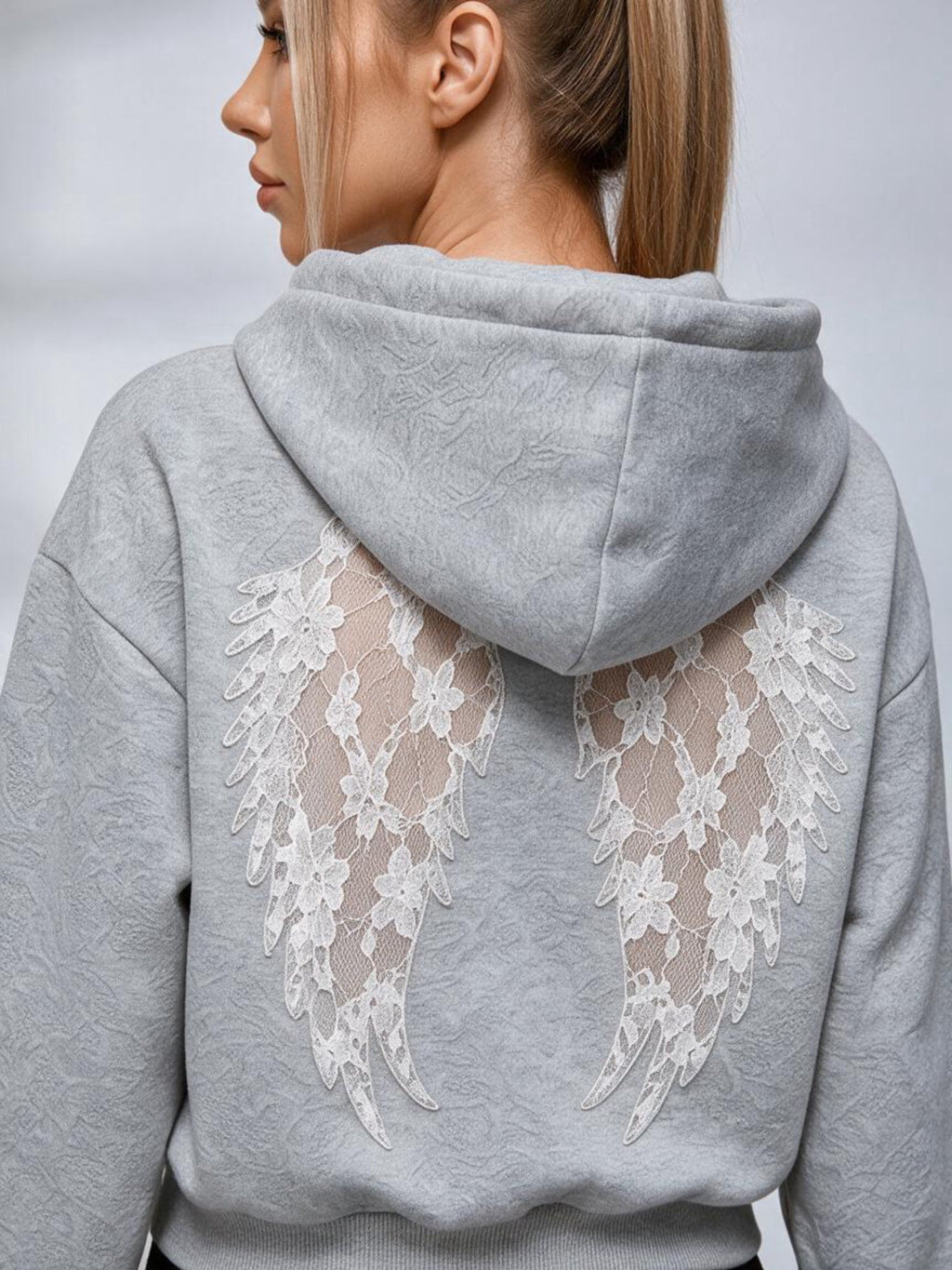 Women's cropped embossed hoodie with drawstring hood and wing back detail