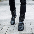 Men's black combat boots with lace-up front and buckle straps