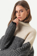 Women's chevron turtleneck sweater with contrasting patterned sleeves