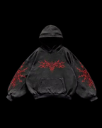 Unisex hooded hoodie with abstract thorn-like chest and sleeve graphics