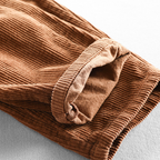 Unisex ribbed corduroy trousers with elasticated waist, side pockets and turned-up hems