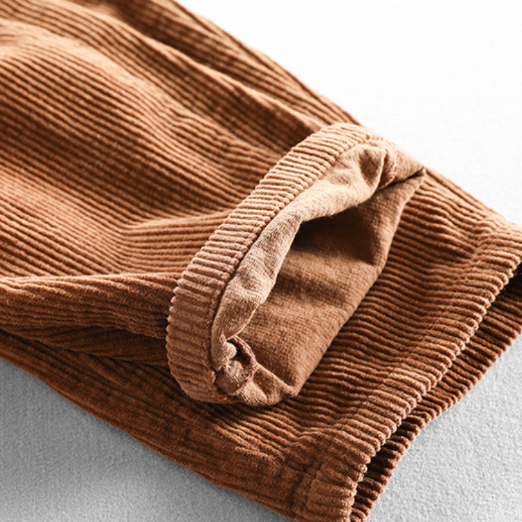 Unisex ribbed corduroy trousers with elasticated waist, side pockets and turned-up hems