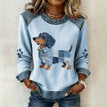 Women's blue and white sweatshirt with a patchwork dog motif and contrasting denim-look trim