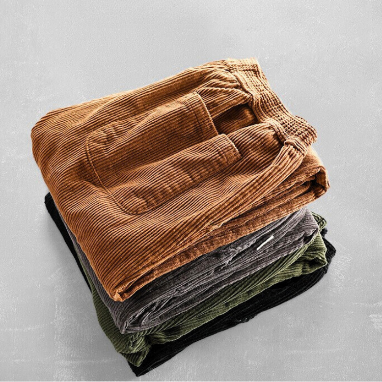 Unisex ribbed corduroy trousers with elasticated waist, side pockets and turned-up hems