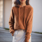 Women's cable knit hooded sweater with drawstrings and long sleeves