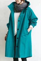 Women's long hooded raincoat with button front and side pockets