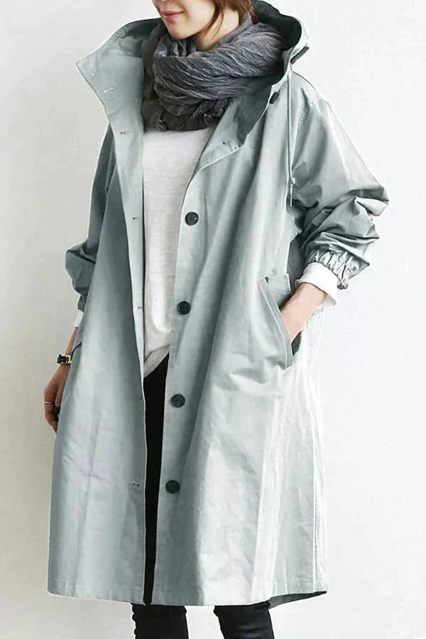 Women's long hooded raincoat with button front and side pockets
