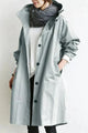 Women's long hooded raincoat with button front and side pockets
