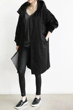 Women's long hooded raincoat with button front and side pockets