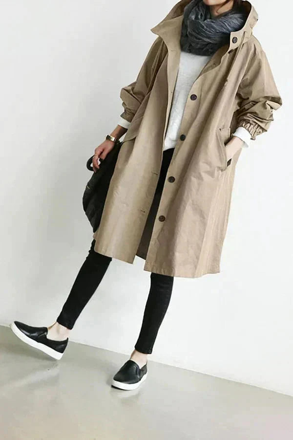 Women's long hooded raincoat with button front and side pockets