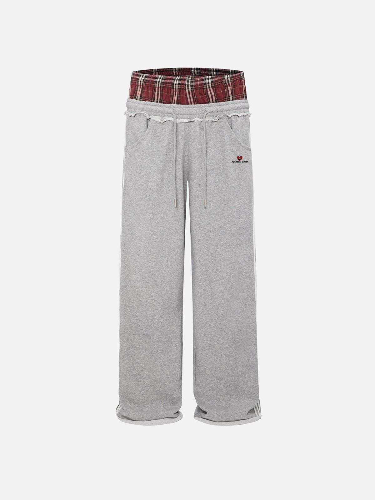 Black wide-leg jogger trousers with checked waistband and drawcords