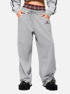 Black wide-leg jogger trousers with checked waistband and drawcords
