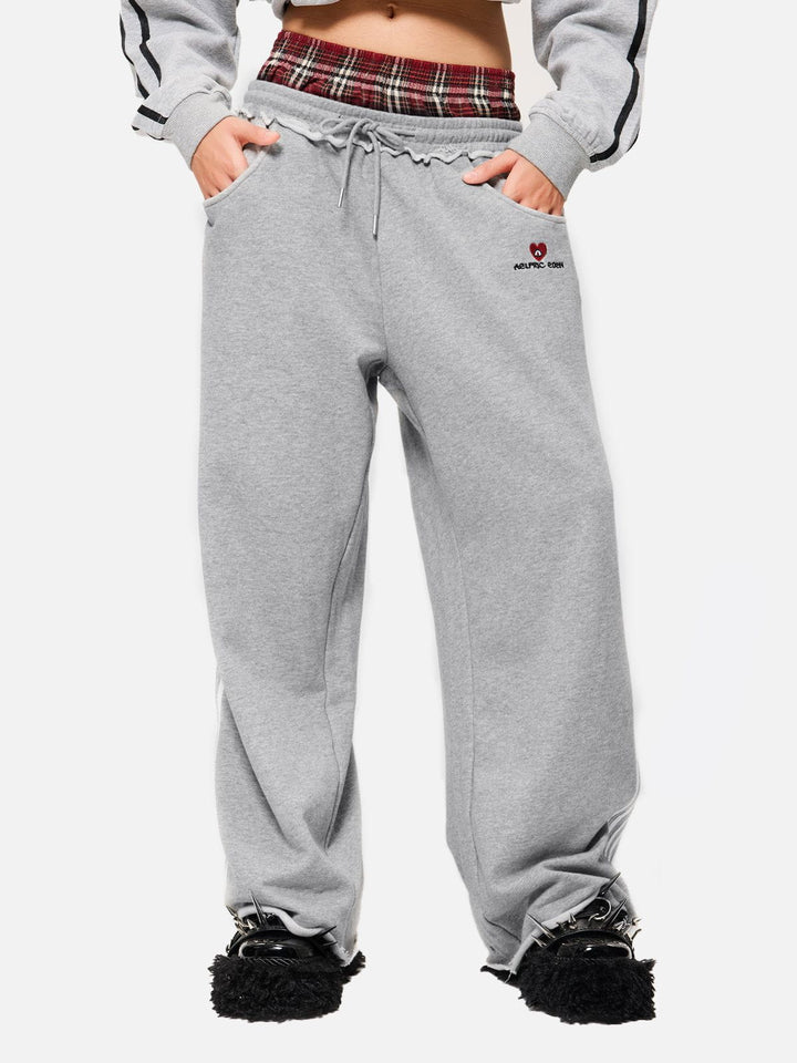 Black wide-leg jogger trousers with checked waistband and drawcords