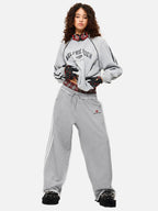 Black wide-leg jogger trousers with checked waistband and drawcords