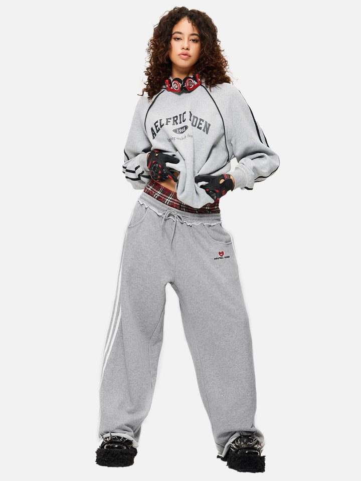 Black wide-leg jogger trousers with checked waistband and drawcords