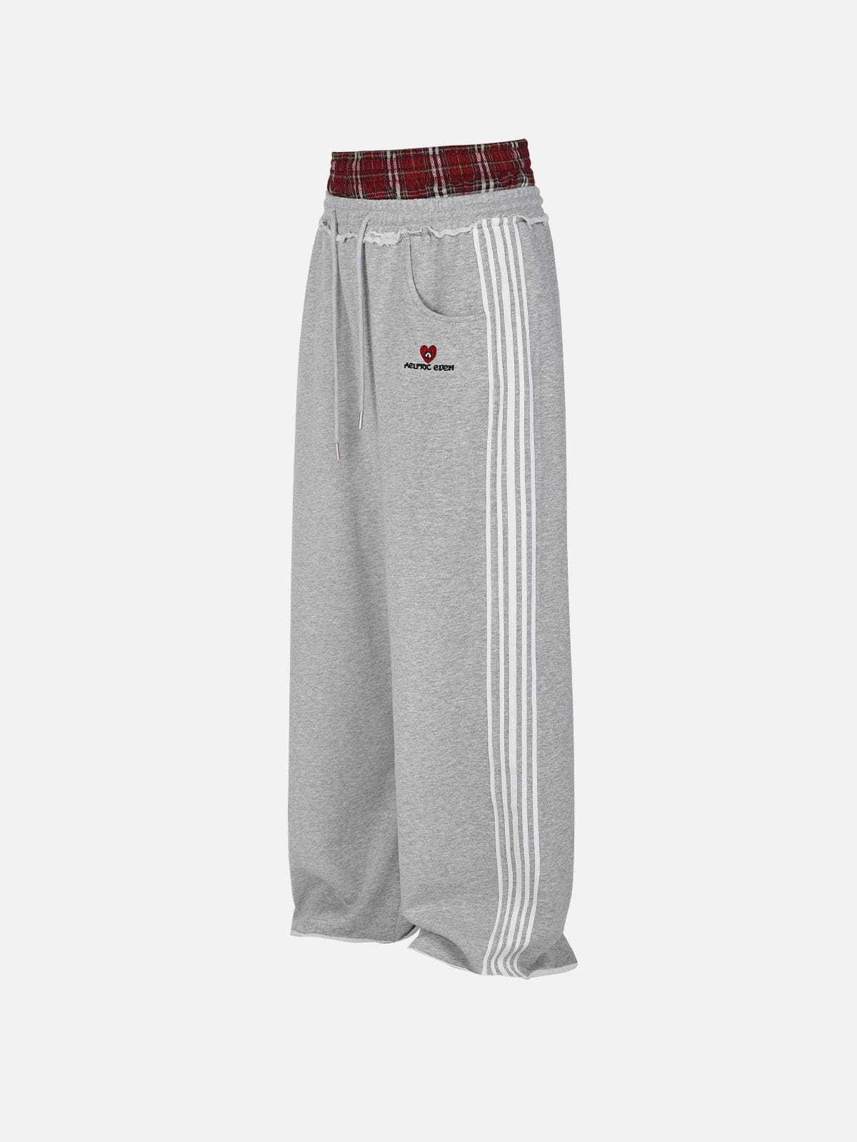 Black wide-leg jogger trousers with checked waistband and drawcords