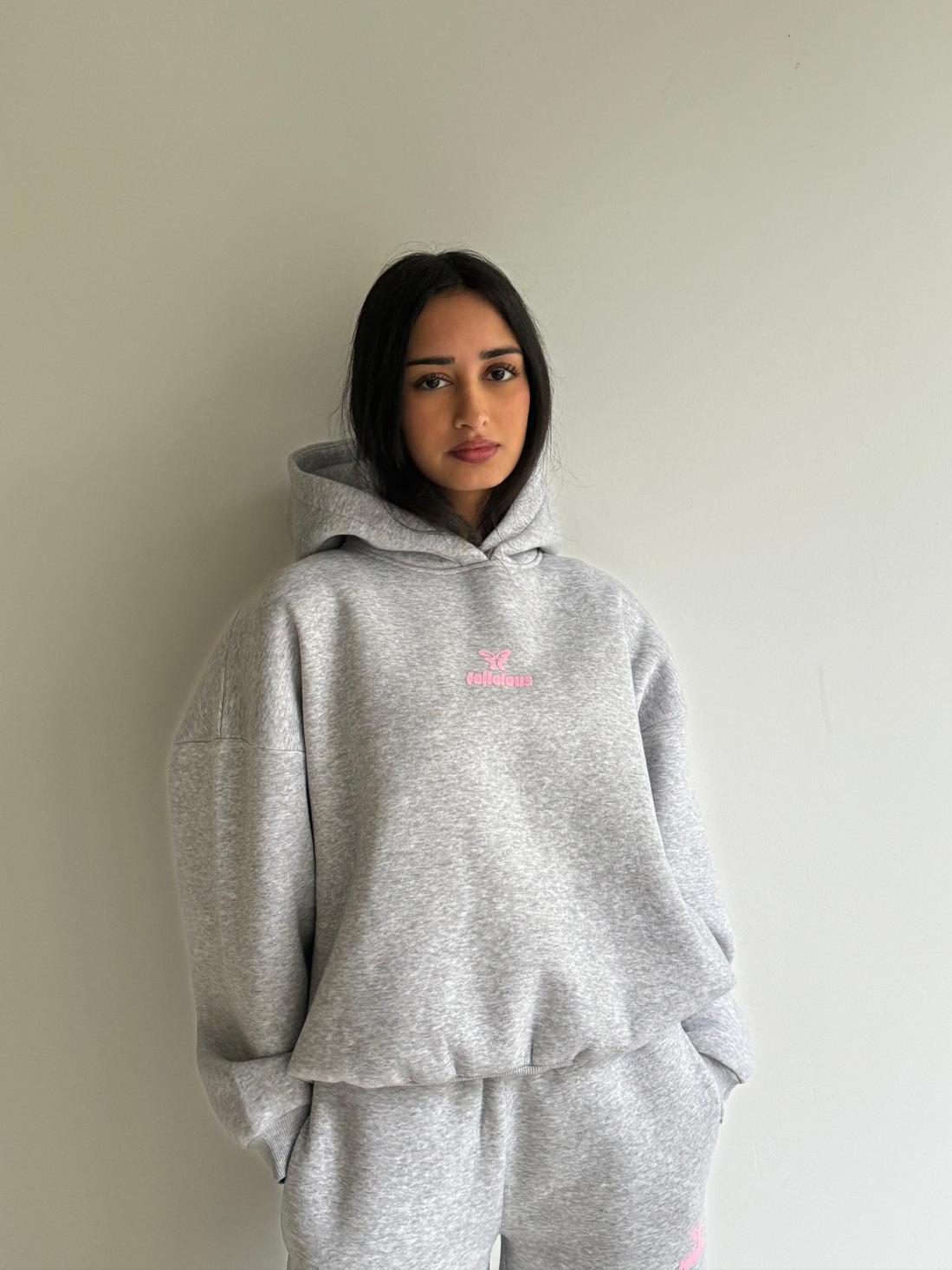 Women's light grey hoodie with pink chest logo and ribbed trims