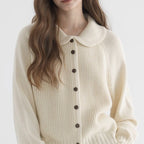 Women's knitted cardigan with rounded collar, long sleeves and button front