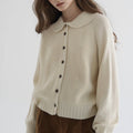 Women's knitted cardigan with rounded collar, long sleeves and button front