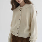 Women's knitted cardigan with rounded collar, long sleeves and button front