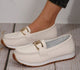 Women's flat loafers with metal buckle and moccasin stitching