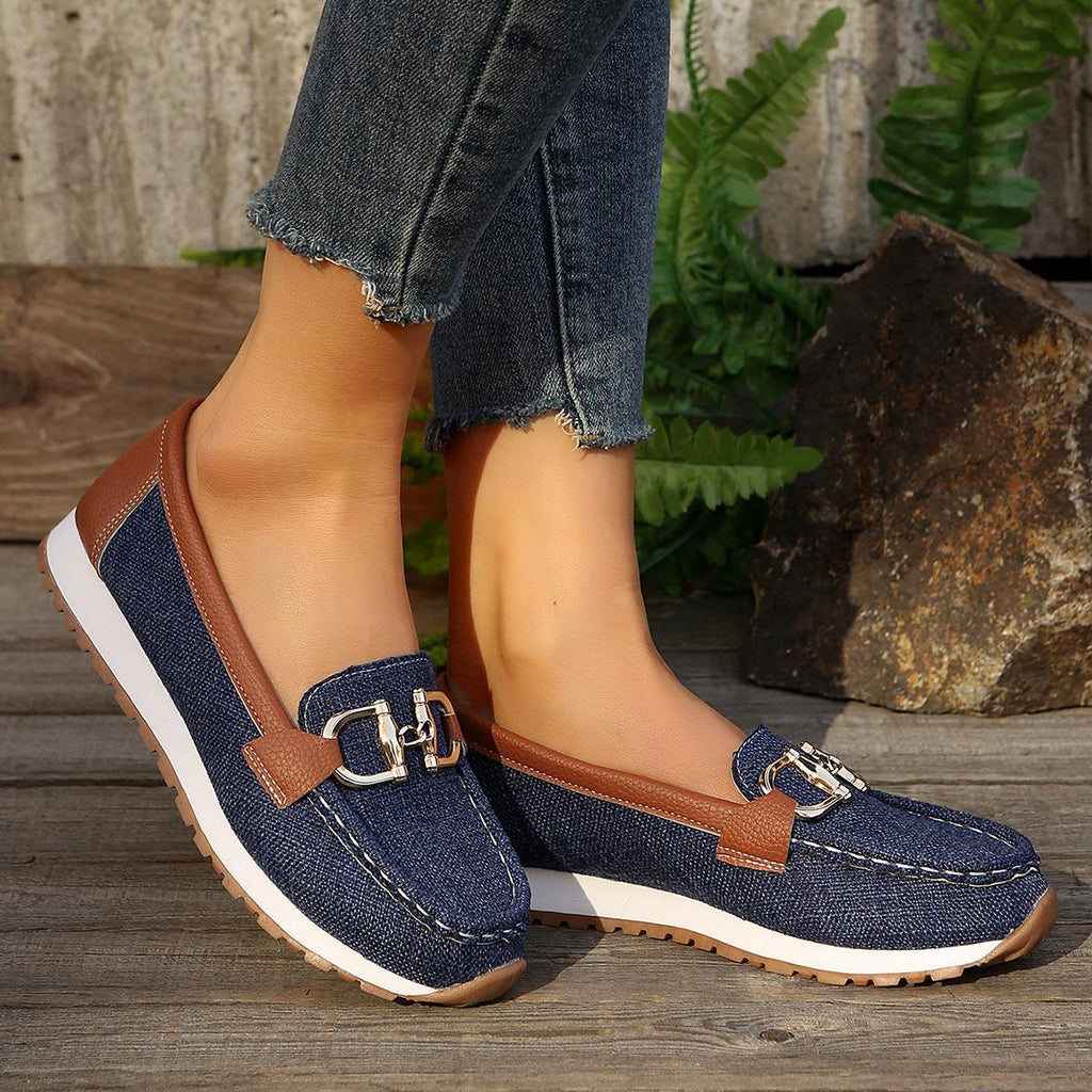 Women's flat loafers with decorative metal buckles and rounded toes