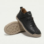 High-top lace-up sneakers with side strap detail and textured flat soles