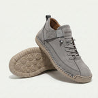 High-top lace-up sneakers with side strap detail and textured flat soles