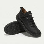 High-top lace-up sneakers with side strap detail and textured flat soles