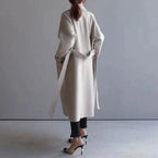 Women's long trench coat with lapels, belt and double-breasted buttons