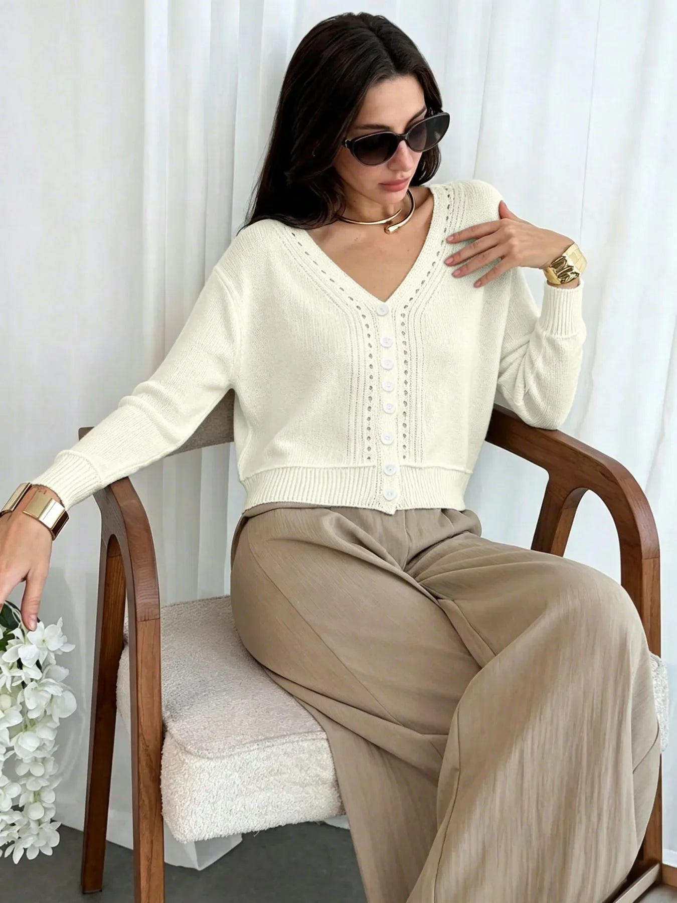 Women's cream cropped cardigan with V-neckline and eyelet knit detail