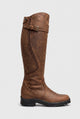 Women's brown knee-high riding boots with a buckle strap and chunky lug sole