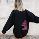 Women's black sherpa fleece hoodie with a slogan print on the back