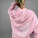 Women's light pink sherpa fleece hoodie with a slogan print on the back