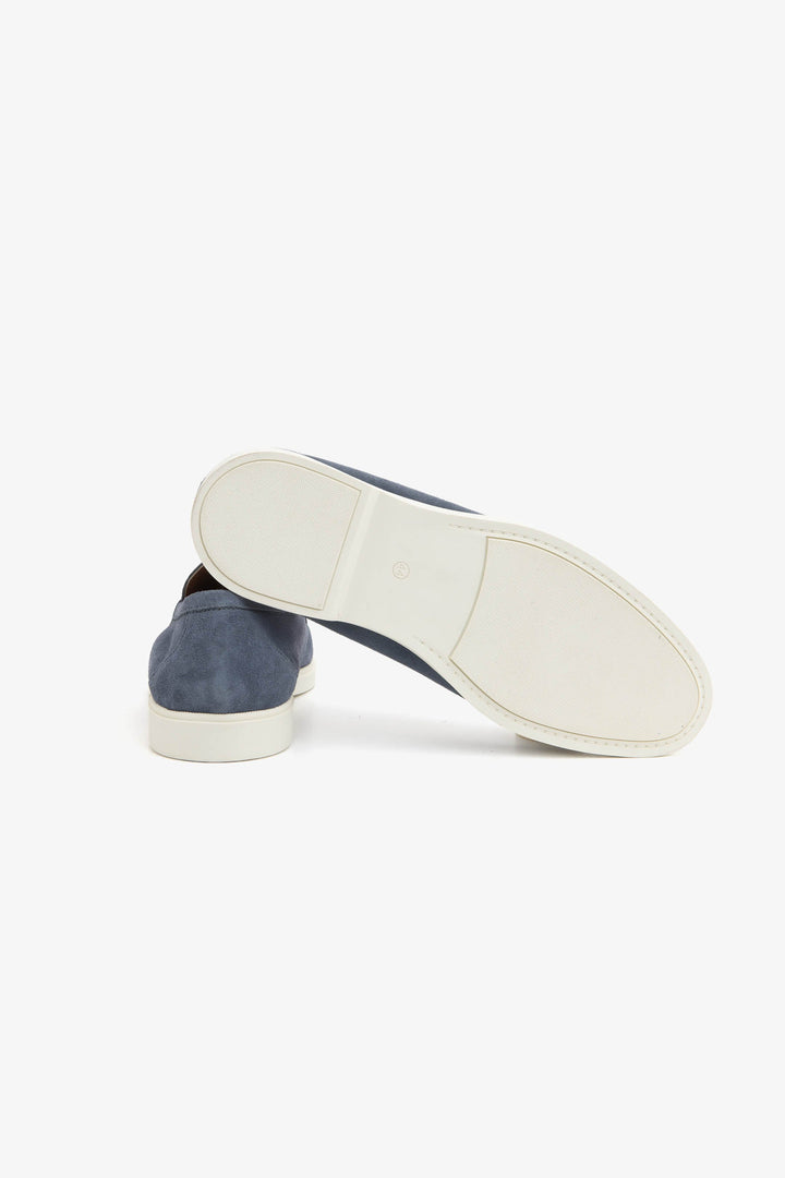 Blue men's slip-on loafers with moccasin stitching and cream flat soles