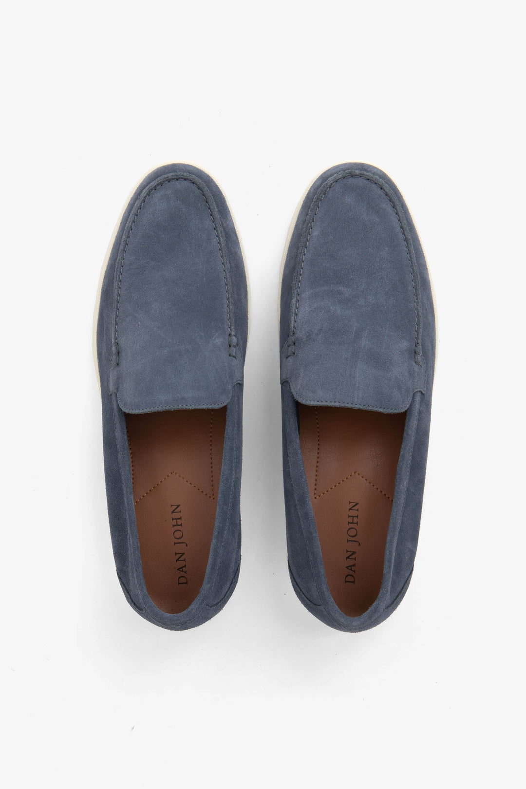 Blue men's slip-on loafers with moccasin stitching and cream flat soles