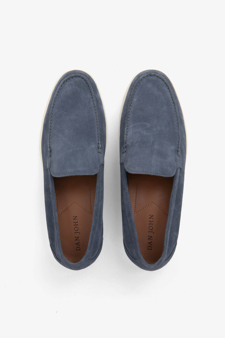 Blue men's slip-on loafers with moccasin stitching and cream flat soles