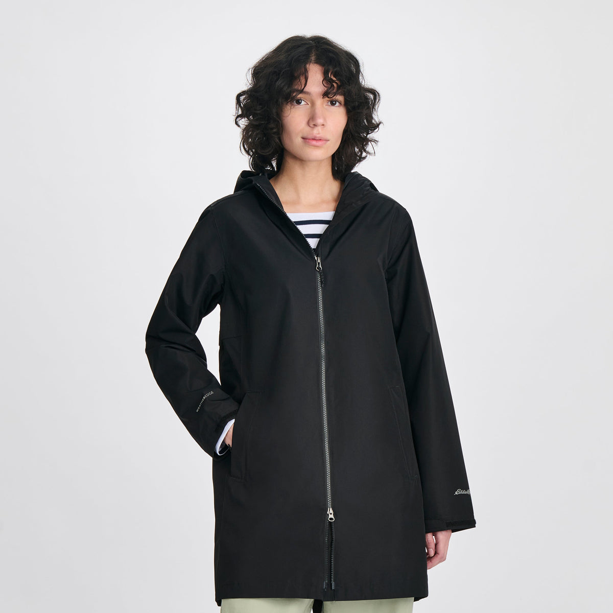 Women's hooded mid-thigh trench coat with long sleeves and zip fastening