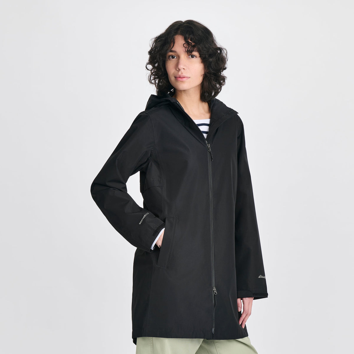 Women's hooded mid-thigh trench coat with long sleeves and zip fastening