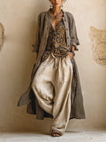 Woman wearing three-piece set with taupe button shirt, patterned scrollwork vest and cream wide-leg trousers