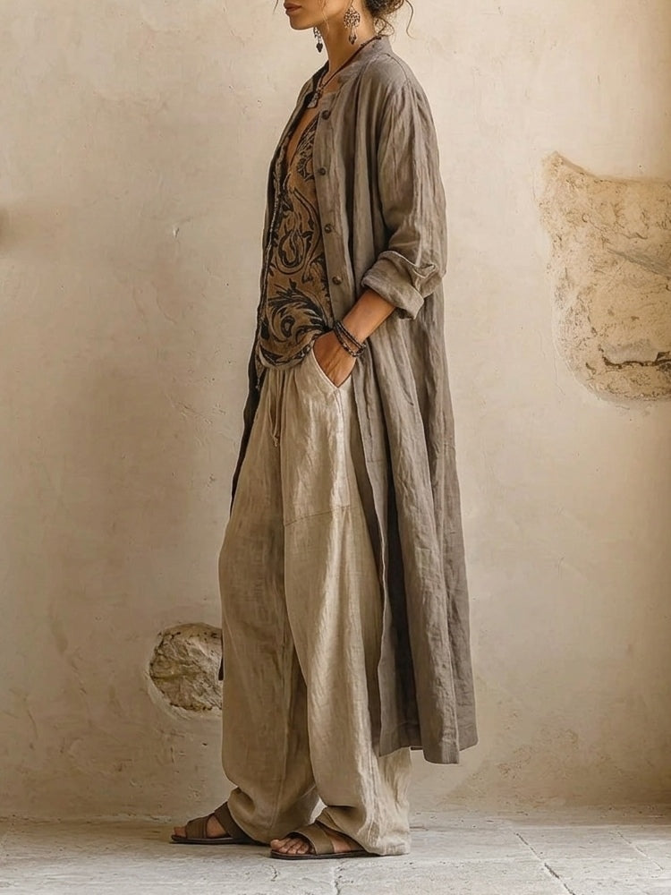 Woman wearing three-piece set with taupe button shirt, patterned scrollwork vest and cream wide-leg trousers