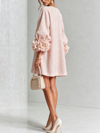 Pink mini dress with long sleeves, flower buttons and large floral cuffs