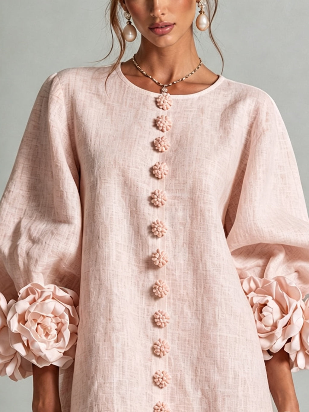 Pink mini dress with long sleeves, flower buttons and large floral cuffs