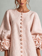 Pink mini dress with long sleeves, flower buttons and large floral cuffs
