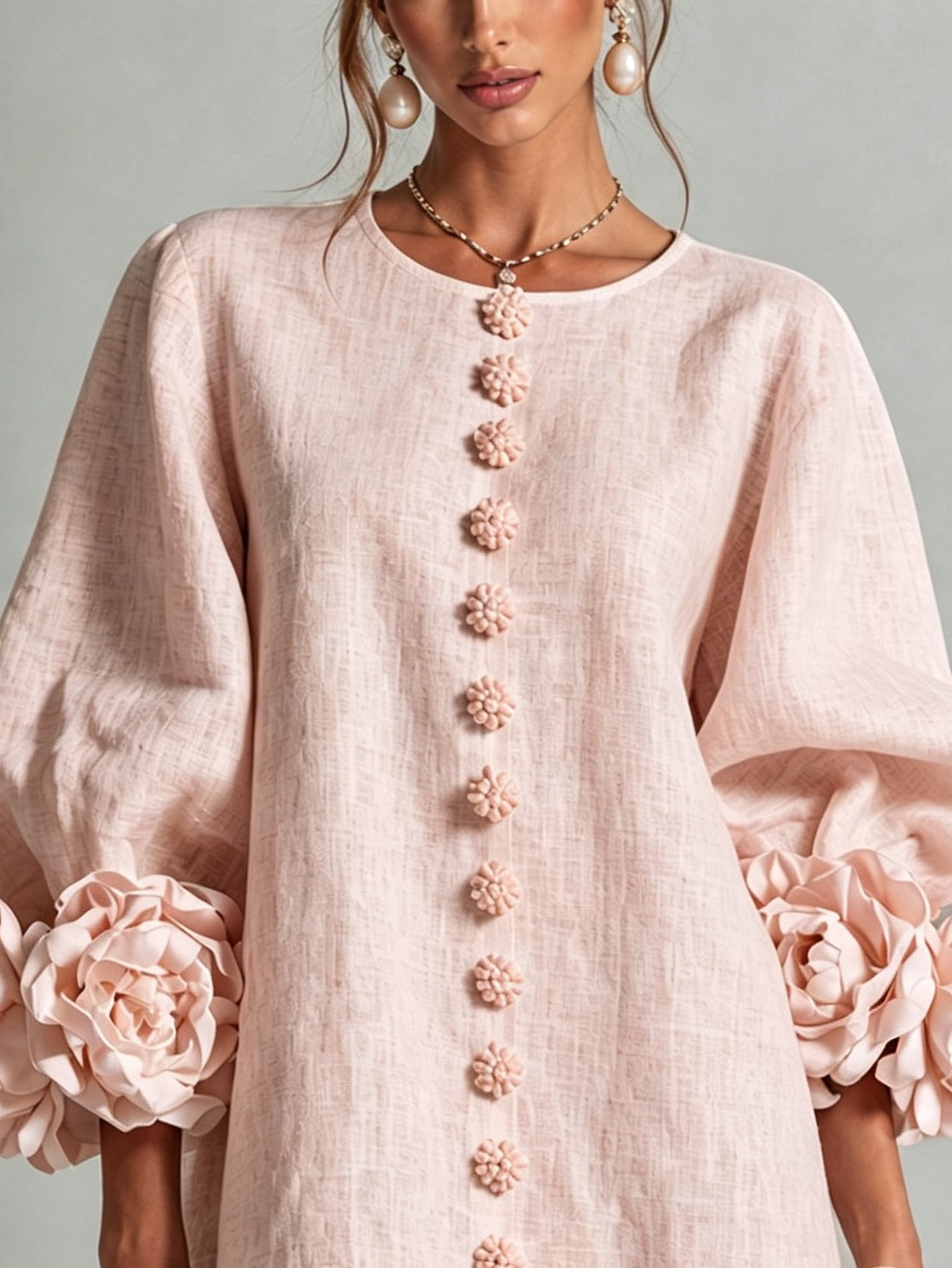 Pink mini dress with long sleeves, flower buttons and large floral cuffs